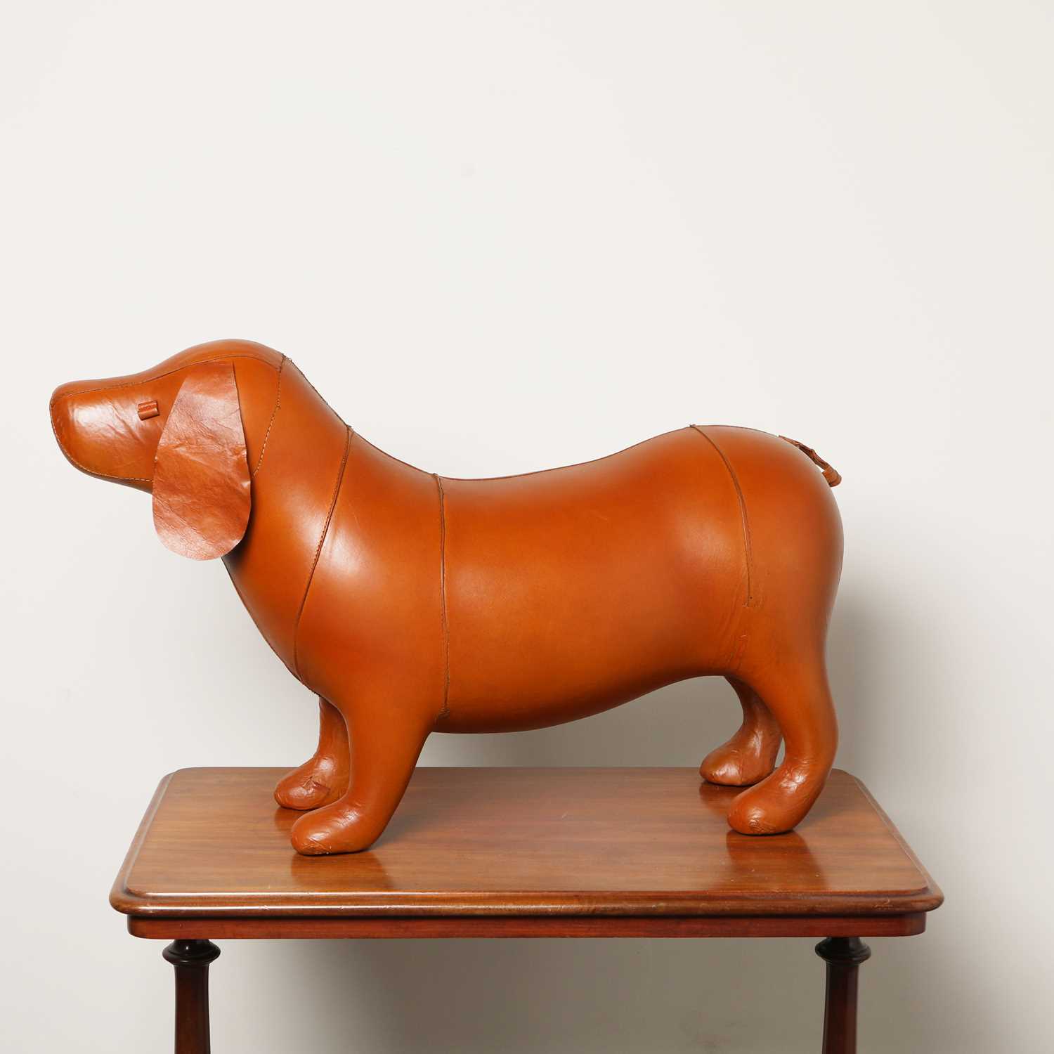 Lot 16 - LEATHERED DOG FORM FOOT STOOL